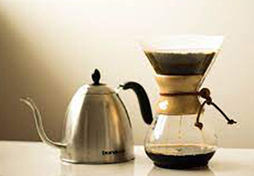 A coffee maker and a glass coffee pot to make a perfect cup of coffee.