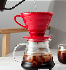 A red coffee pot with a red lid.