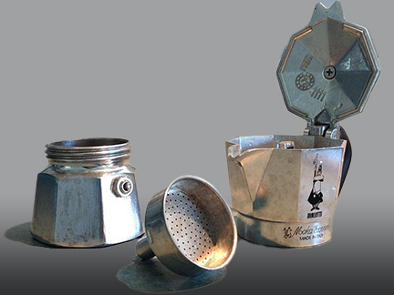 Disassembled Bialetti Moka Pot showcasing its simple three - chamber design, highlighting the classic Italian stovetop coffee maker's history and functionality