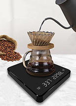 A digital scale displaying weight and brew time, capturing the precise moment hot water is poured from a gooseneck kettle into a pour over coffee setup, essential for achieving a consistently exceptional brew.